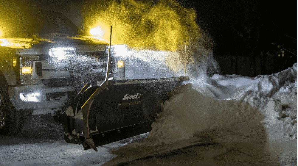 Heavy-Duty Snow Removal Truck with a Blade in Severe Weather.